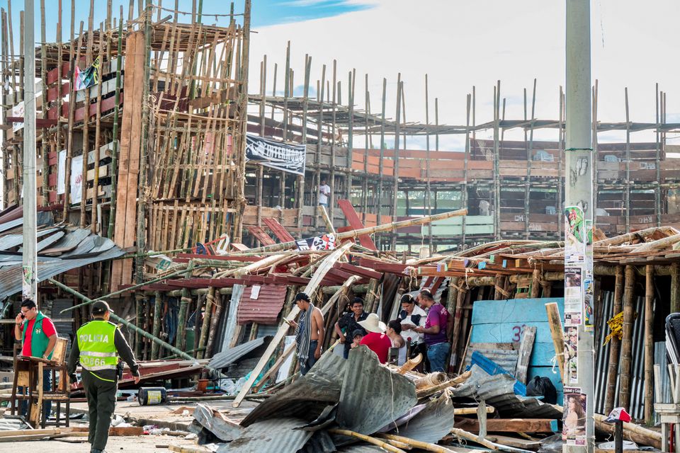 People gather near the rubble of a grandstand that collapsed in a bullring during the celebrations of the San Pedro festivities, in El Espinal, Colombia June 26, 2022. Photo: Reuters