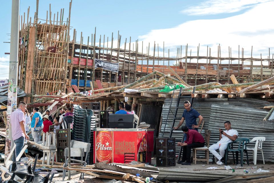 Residents gather near the rubble of some stands that collapsed in a bullring during the celebrations of the San Pedro festivities, in El Espinal, Colombia June 26, 2022. Photo: Reuters
