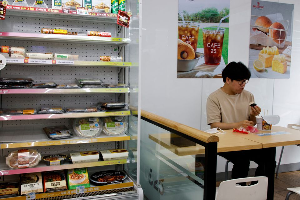 An office worker eats his lunch at a convenience store in Seoul, South Korea, June 24, 2022. Photo: Reuters