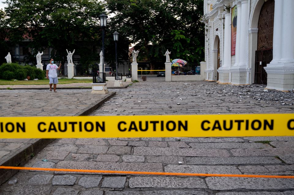 A man takes a picture of a damaged church in the aftermath of an earthquake in Vigan City, Ilocos Sur, Philippines, July 28, 2022. Photo: Reuters
