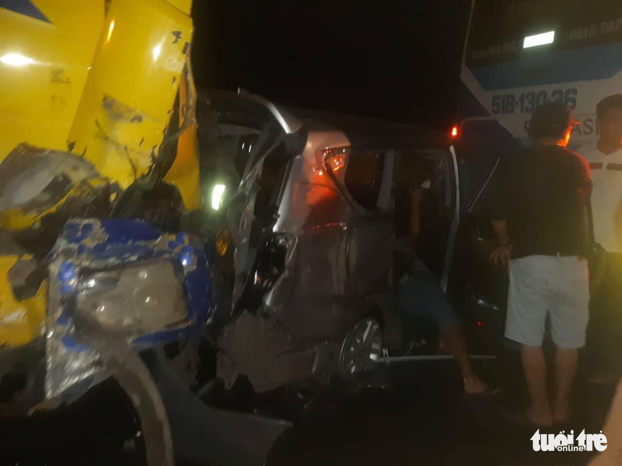 A seven-seater car is squeezed by a truck and a passenger bus in a serial traffic accident on the Ho Chi Minh City-Long Thanh-Dau Giay Expressway, Vietnam, August 2, 2022. Photo: Handout via Tuoi Tre