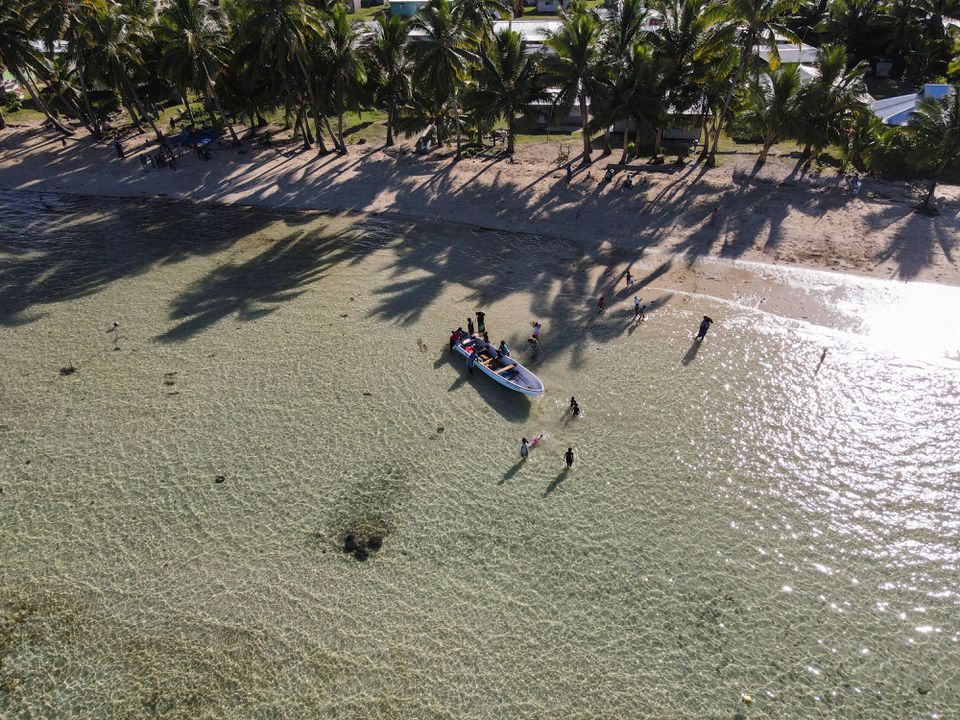 Fijian fisherwomen gather near a boat after returning from harvesting sea grapes at sea, near Namuaimada village, Viti Levu, Fiji July 14, 2022. Picture taken with a drone. Photo: Reuters