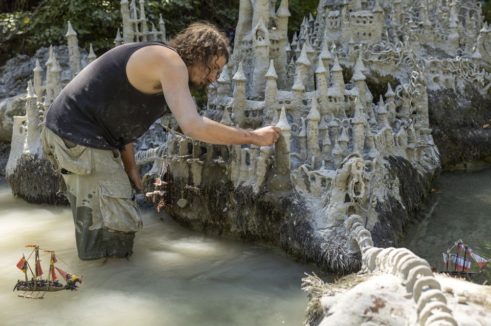 Land art artist Francois Monthoux works on his 'Monthoux castle' made out of clay retrieved from the dried bed of Le Toleure river due to ongoing drought, in Saubraz, Switzerland, August 12, 2022. Photo: Reuters