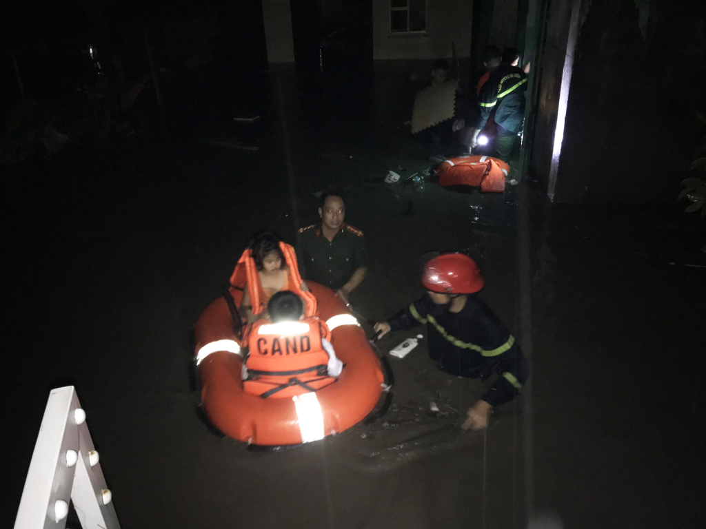People are evacuated from a flooded neighborhood in Quang Ninh Province, Vietnam, August 25, 2022 in this supplied photo.