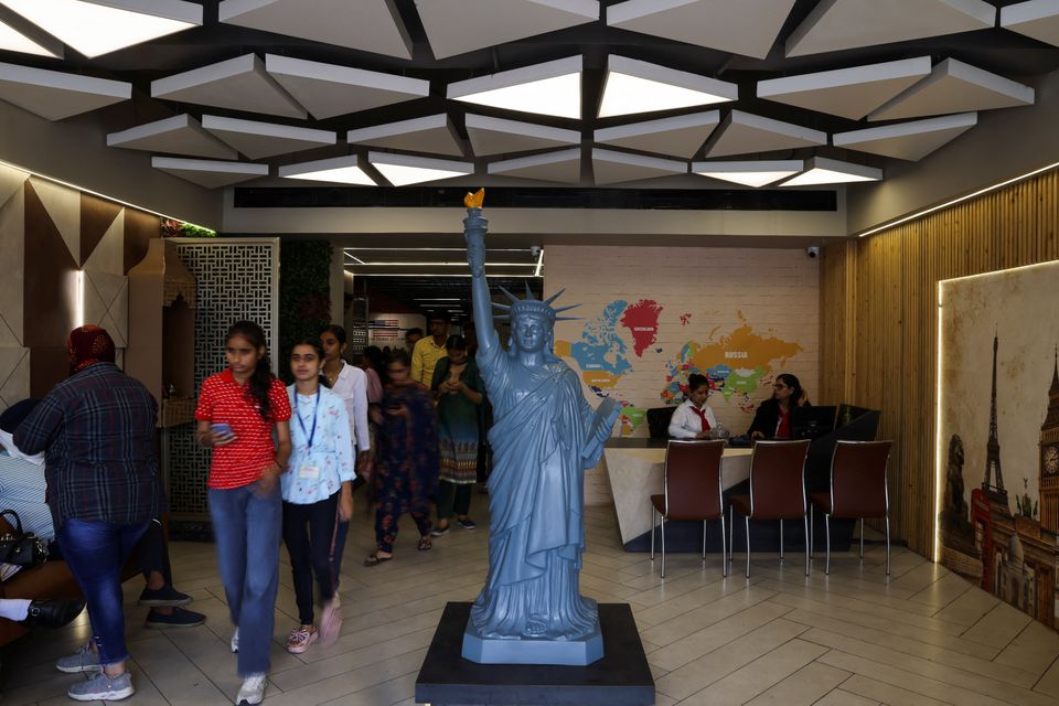 Students walk in the lobby of Western Overseas, an institute providing coaching for English language proficiency tests and visa consultancy, in Ambala, India, August 4, 2022. Photo: Reuters
