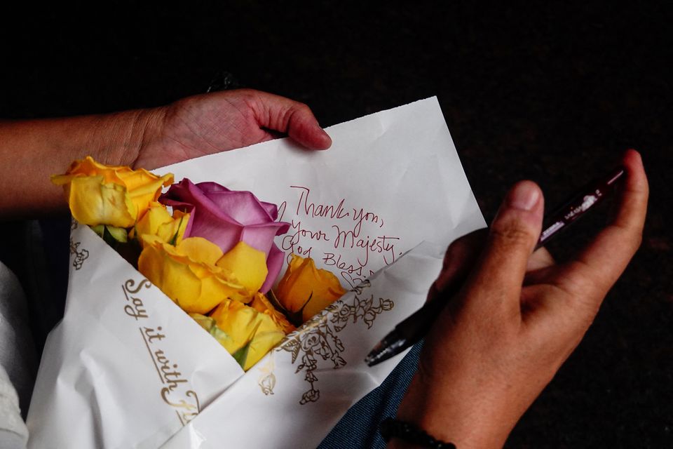 Melina Yanez of New York lays a set of flowers near the British Consulate General, after Queen Elizabeth, Britain's longest-reigning monarch and the nation's figurehead for seven decades, has died aged 96, in New York, U.S., September 8, 2022. Photo: Reuters