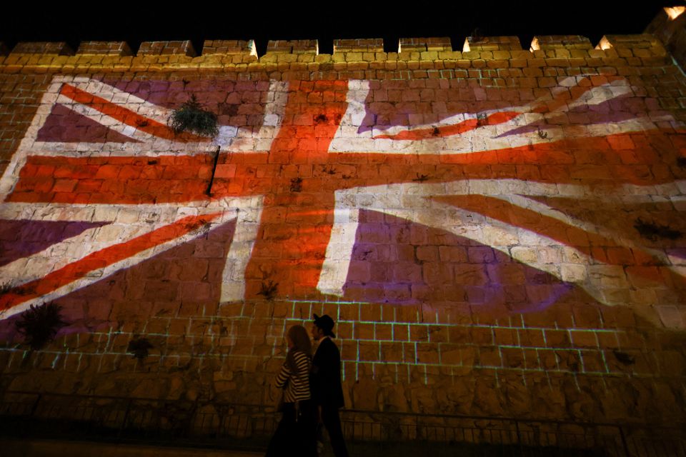 A fragment of the walls of Jerusalem's Old City is illuminated with the Union Jack flag following the death of Queen Elizabeth, Britain's longest-reigning monarch, in Jerusalem September 8, 2022. Photo: Reuters
