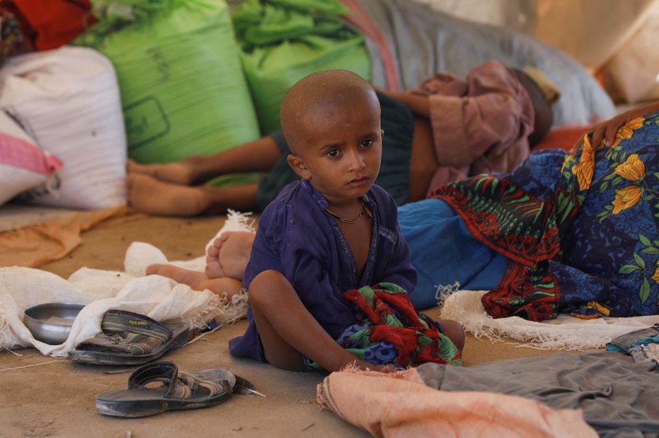 A displaced boy sits as his family takes refuge in a camp, following rains and floods during the monsoon season in Sehwan, Pakistan, September 16, 2022. Photo: Reuters