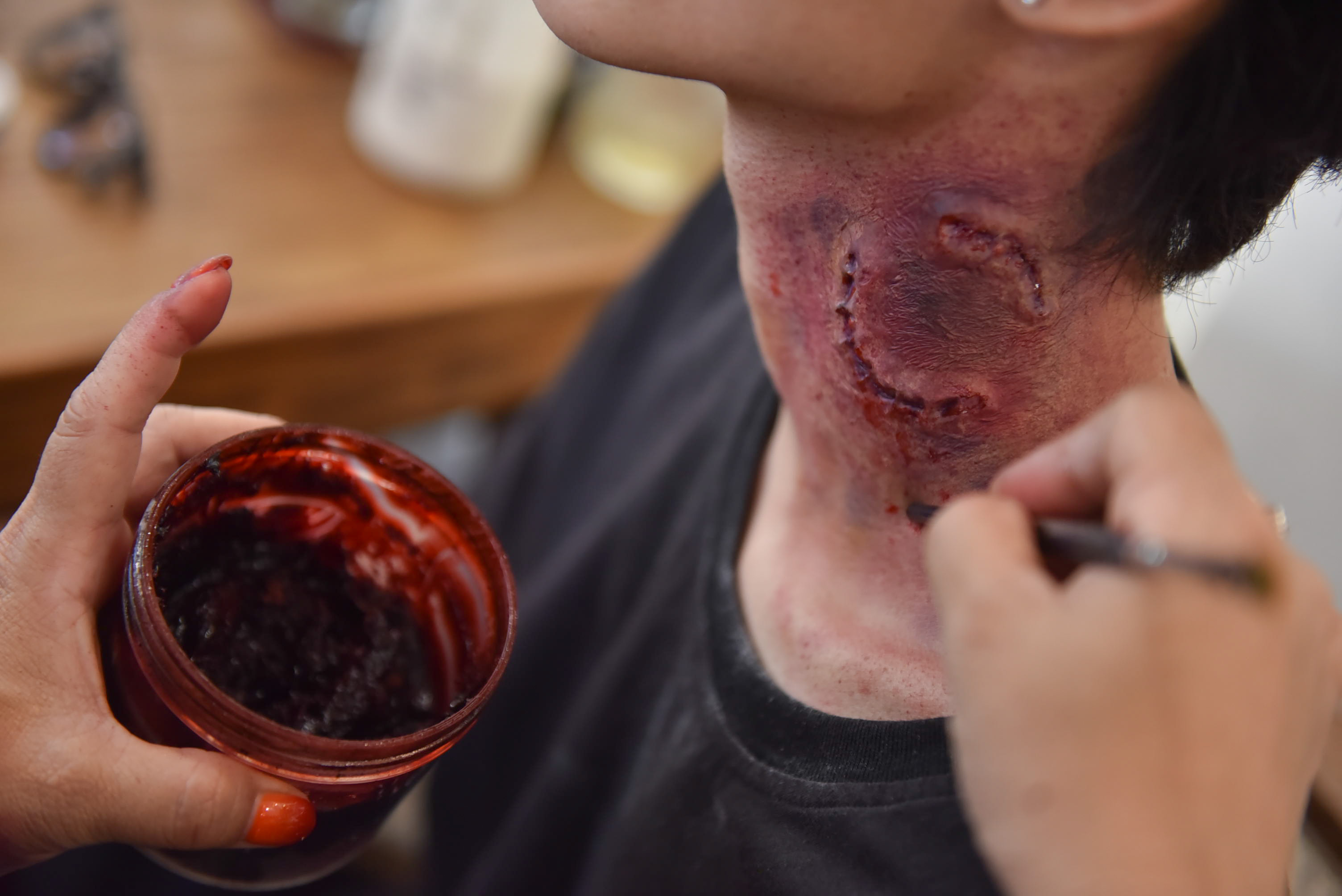 It takes Hang ten minutes to create a zombie bite on the neck of the actor. Photo: Ngoc Phuong / Tuoi Tre News