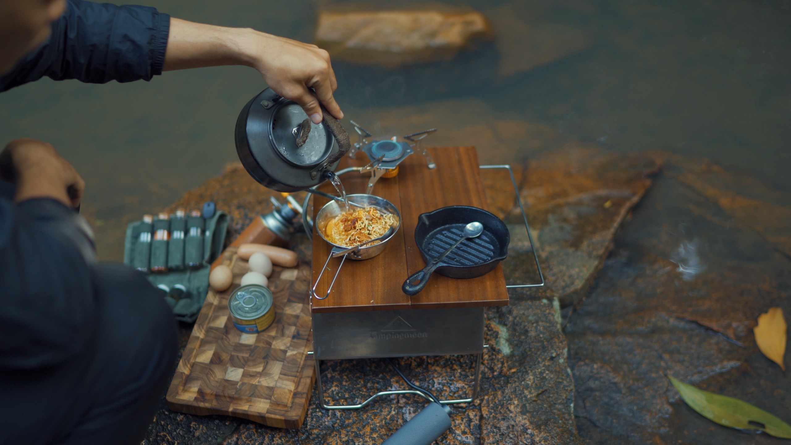 A supplied photo shows Lu Hoang Thong cooking his food by a spring during a solo trip.