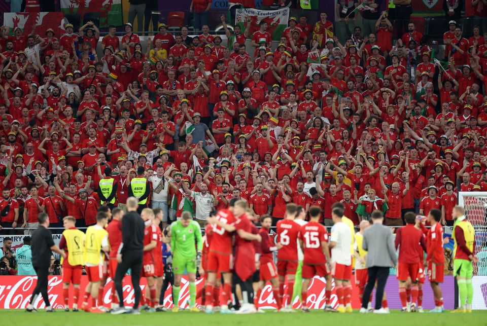 Soccer Football - FIFA World Cup Qatar 2022 - Group B - United States v Wales - Ahmad Bin Ali Stadium, Al Rayyan, Qatar - November 22, 2022 Wales players and fan celebrate after the match. Photo: Reuters