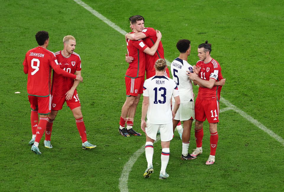 Soccer Football - FIFA World Cup Qatar 2022 - Group B - United States v Wales - Ahmad Bin Ali Stadium, Al Rayyan, Qatar - November 22, 2022 Wales' Gareth Bale, Aaron Ramsey and Brennan Johnson with Antonee Robinson and Tim Ream of the U.S. after the match. Photo: Reuters