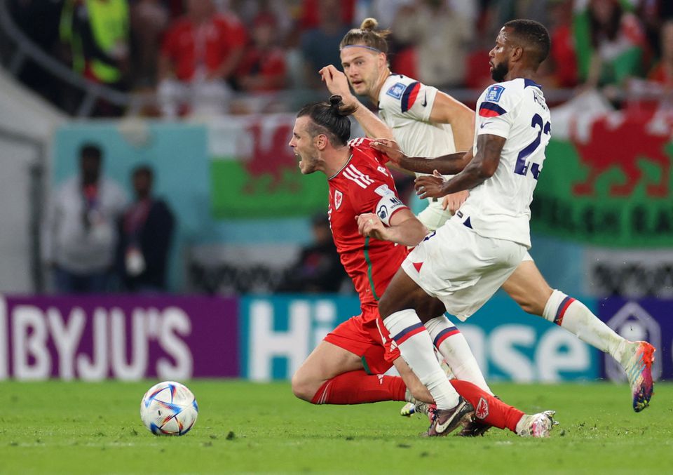 Soccer Football - FIFA World Cup Qatar 2022 - Group B - United States v Wales - Ahmad Bin Ali Stadium, Al Rayyan, Qatar - November 21, 2022 Wales' Gareth Bale is fouled by Kellyn Acosta of the U.S. Photo: Reuters