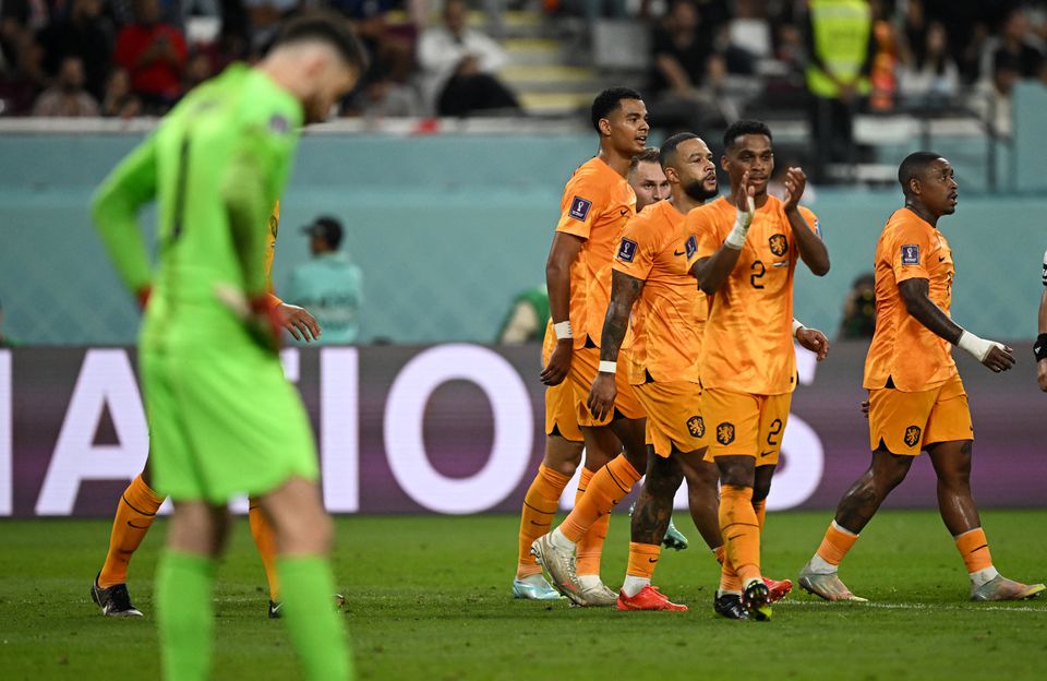 Soccer Football - FIFA World Cup Qatar 2022 - Round of 16 - Netherlands v United States - Khalifa International Stadium, Doha, Qatar - December 3, 2022 Netherlands' Jurrien Timber and Memphis Depay celebrate their third goal scored by Denzel Dumfries. Photo: Reuters