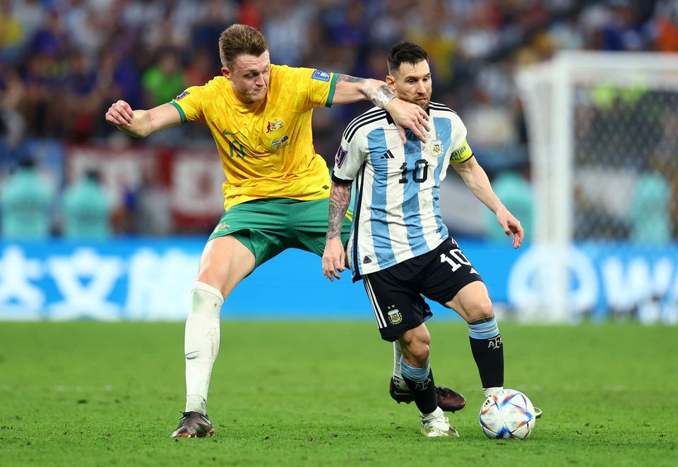 Soccer Football - FIFA World Cup Qatar 2022 - Round of 16 - Argentina v Australia - Ahmad bin Ali Stadium, Al Rayyan, Qatar - December 3, 2022 Argentina's Lionel Messi in action with Australia's Harry Souttar. Photo: Reuters