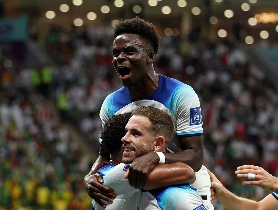 Soccer Football - FIFA World Cup Qatar 2022 - Round of 16 - England v Senegal - Al Bayt Stadium, Al Khor, Qatar - December 4, 2022 England's Jordan Henderson celebrates scoring their first goal with Bukayo Saka. Photo: Reuters