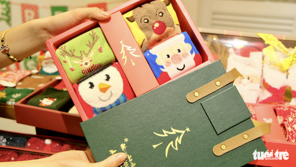 This image shows a box of four pairs of socks printed with pine trees, reindeer and other Xmas topics at a shop in Ho Chi Minh City. Photo: Bong Mai / Tuoi Tre