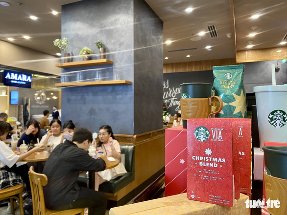 A Christmas-styled coffee chain shop, based in Ho Chi Minh City, is seen being filled with guests in this image. Photo: Bong Mai / Tuoi Tre