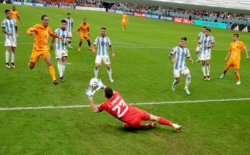 Soccer Football - FIFA World Cup Qatar 2022 - Quarter Final - Netherlands v Argentina - Lusail Stadium, Lusail, Qatar - December 9, 2022 Argentina's Emiliano Martinez makes a save as Netherlands' Virgil van Dijk reacts REUTERS/Carl Recine