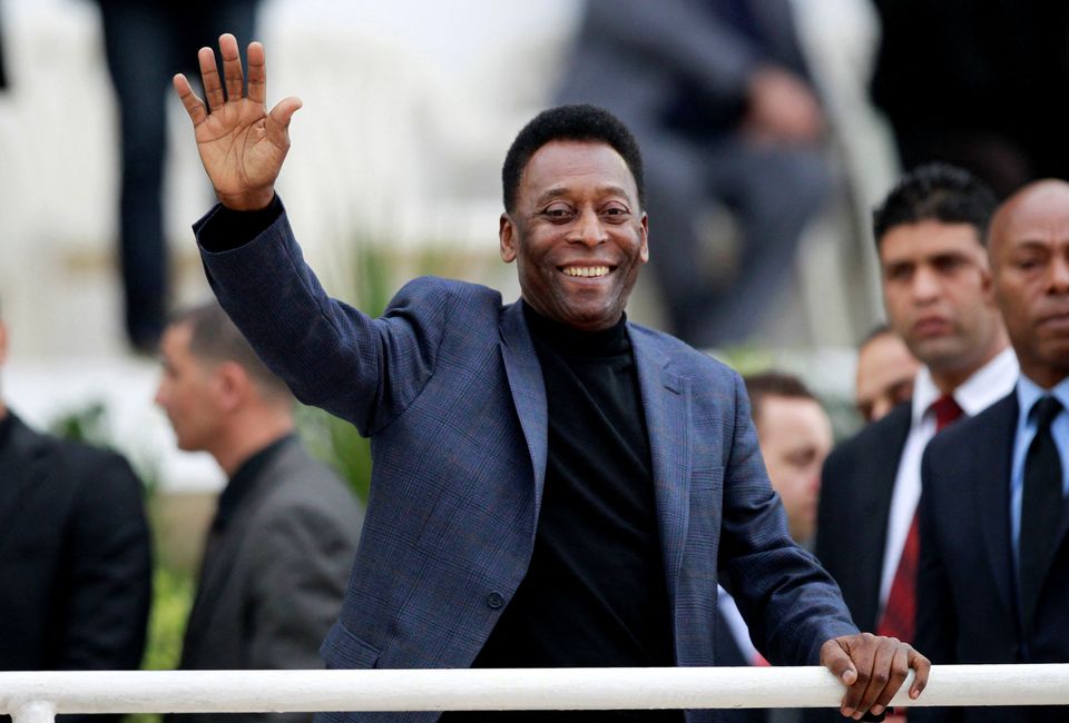 Brazilian soccer legend Pele waves during the international friendly soccer match between Algeria and Slovenia in Algiers, Algeria March 5, 2014. REUTERS/Louafi Larbi
