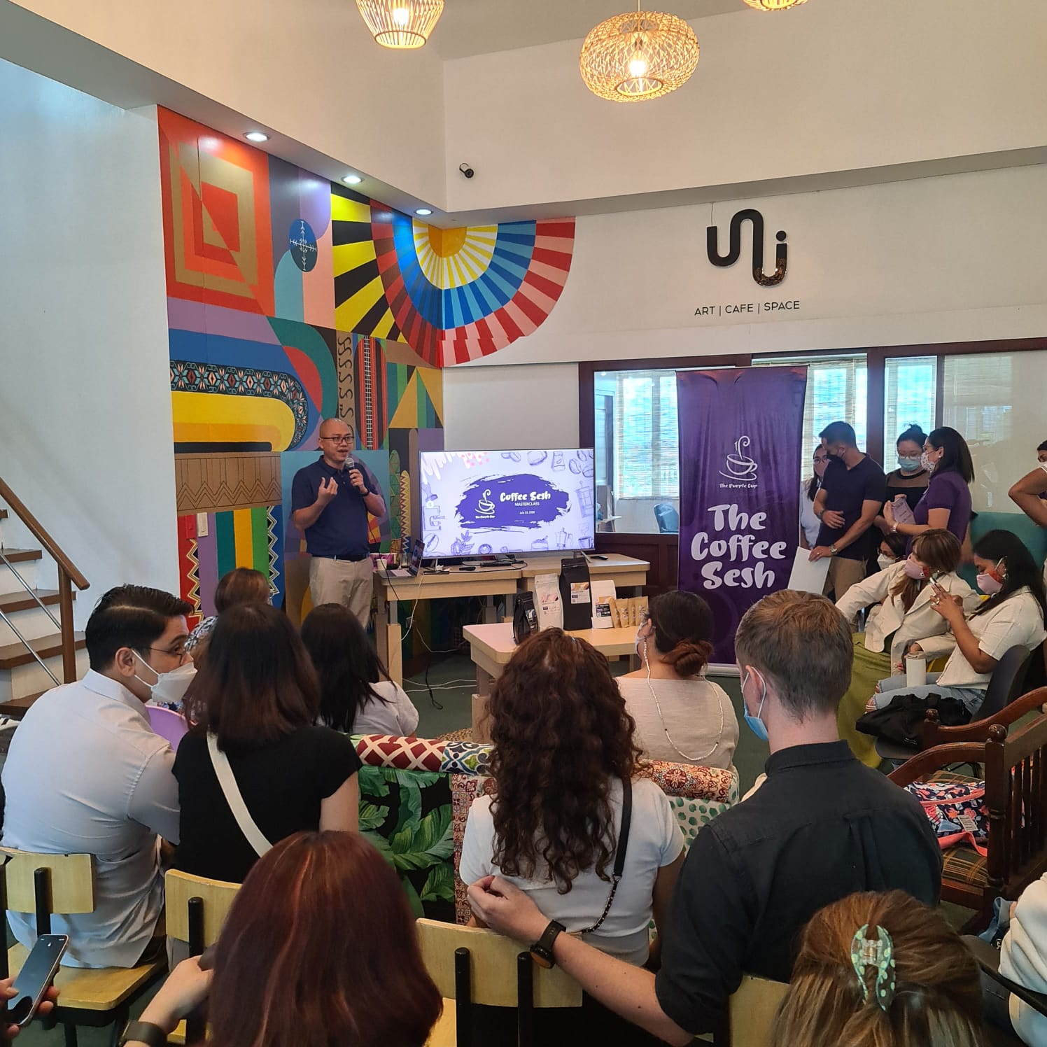 Jackie Vuong (standing) introduces Vietnamese coffee at a workshop in Manila in July 2022 in this supplied photo.