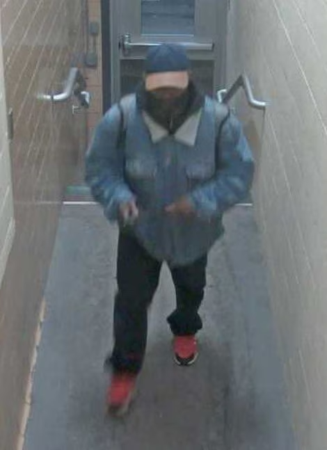 A person, thought to be the suspect, walks up a flight of stairs as he enters a building, amidst a shooting incident, at Michigan State University in East Lansing, Michigan, U.S. February 13, 2023. Photo: MSU Police and Public Safety via Twitter/via Reuters