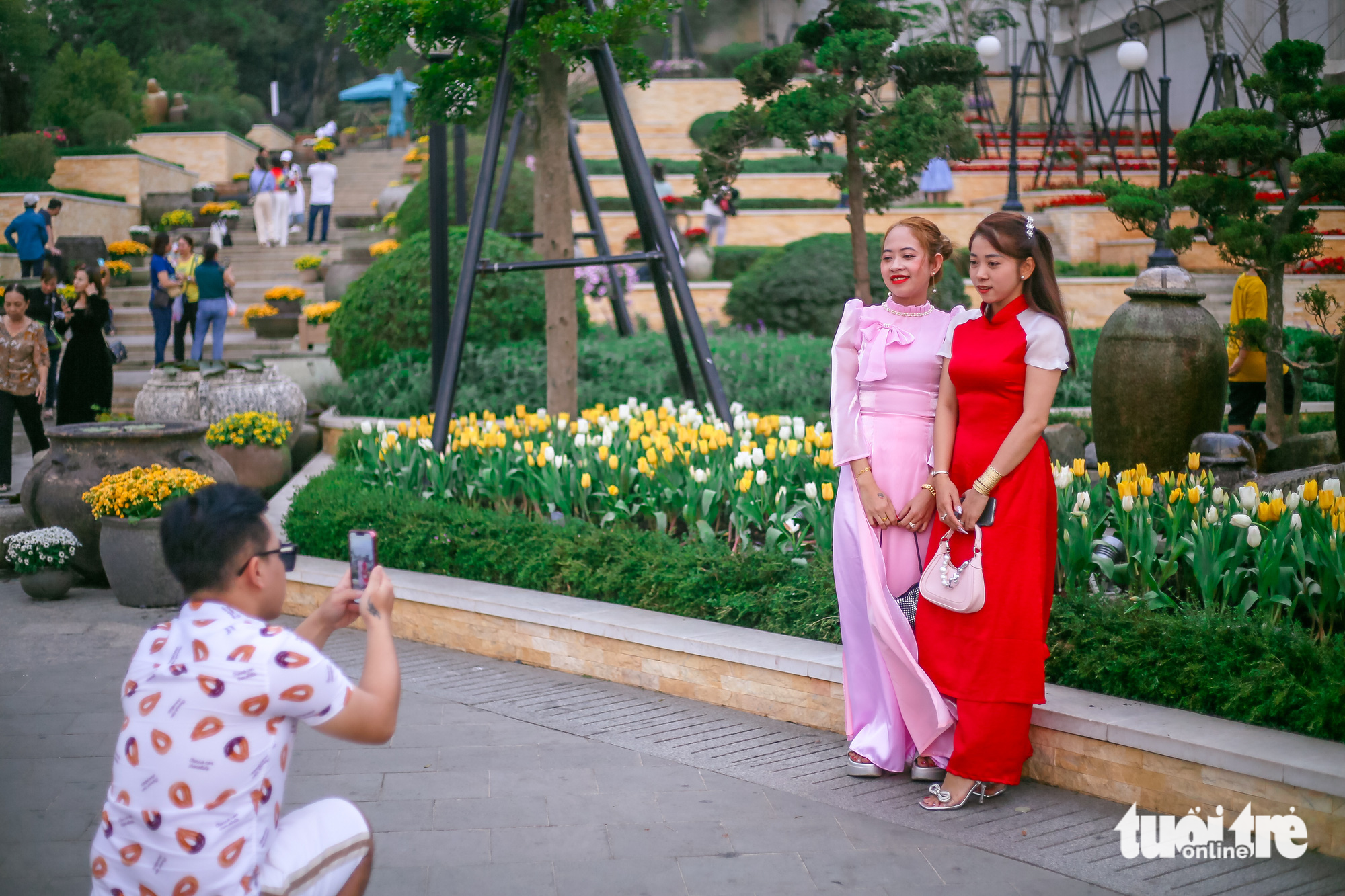 Visitors pose for a photo in a tulip garden at the Ba Den Mountain tourist site in Tay Ninh Province. Photo: Chau Tuan / Tuoi Tre