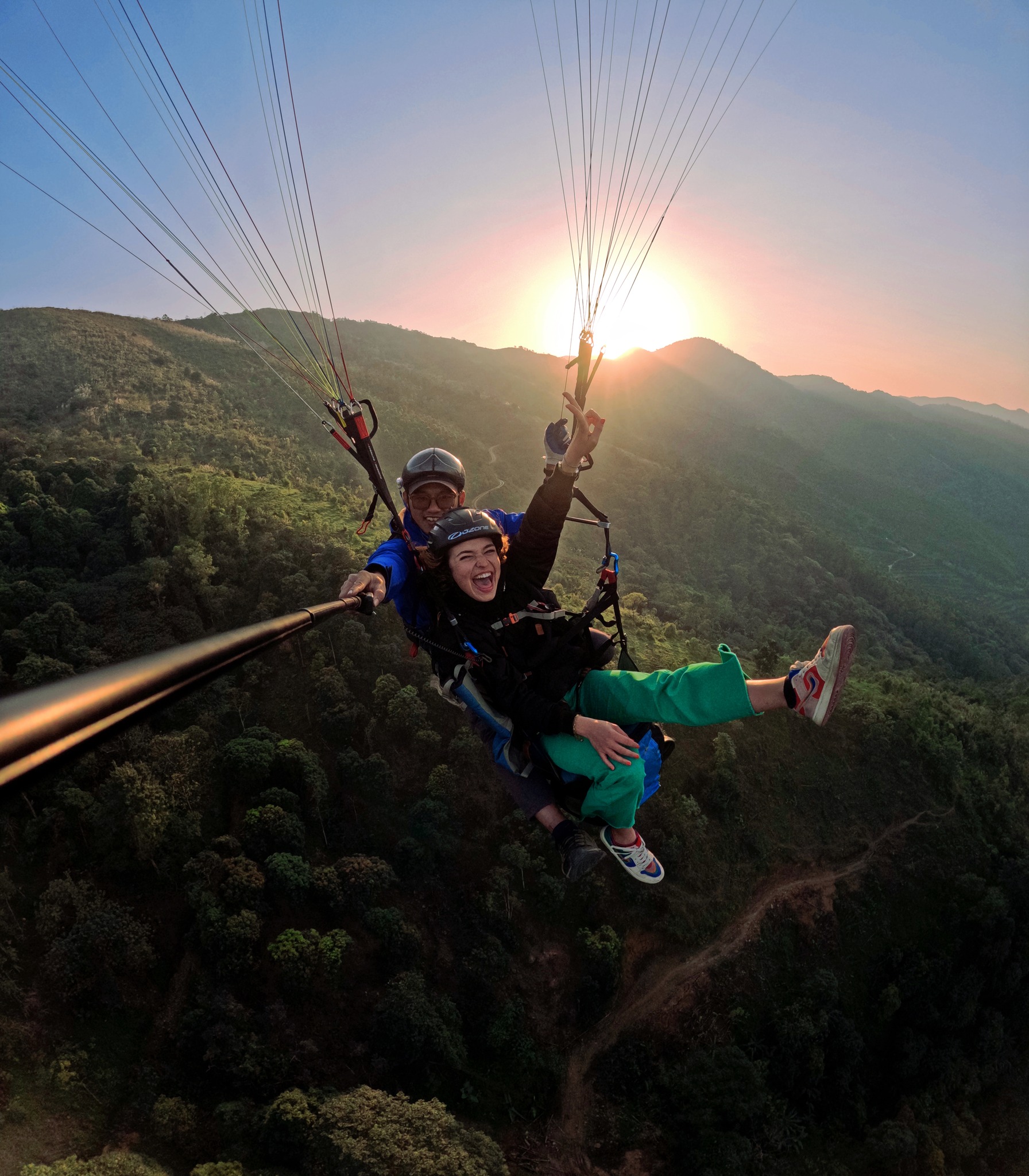 A professional accompanies and films while a tourist enjoys paragliding at Bu Hill on the outskirts of Hanoi, Vietnam. Photo by courtesy of Mebayluon