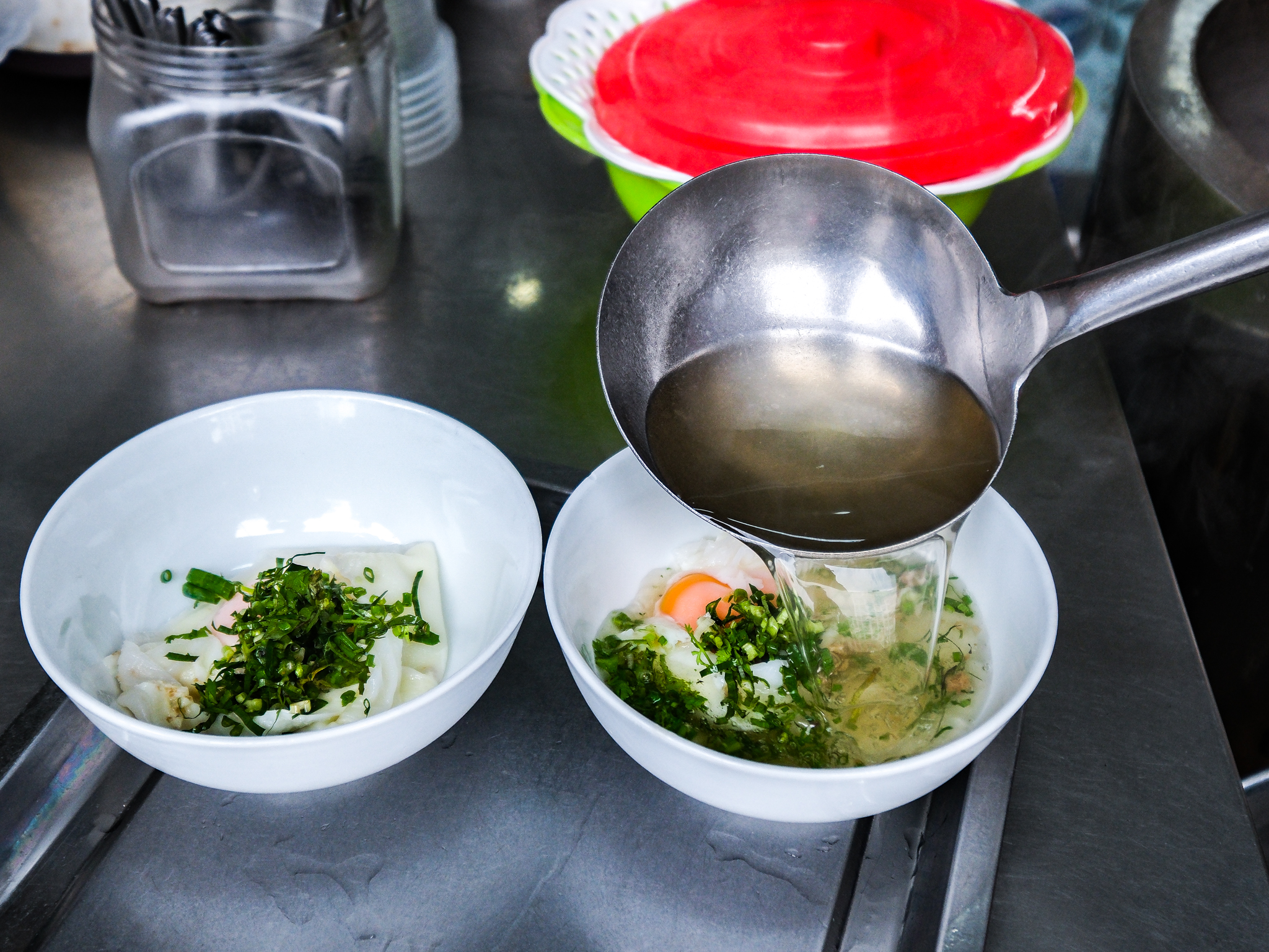 Broth is made to serve with banh cuon at Banh Cuon Cao Bang stall in Hanoi, Vietnam. Photo: Nam Tran / Tuoi Tre News