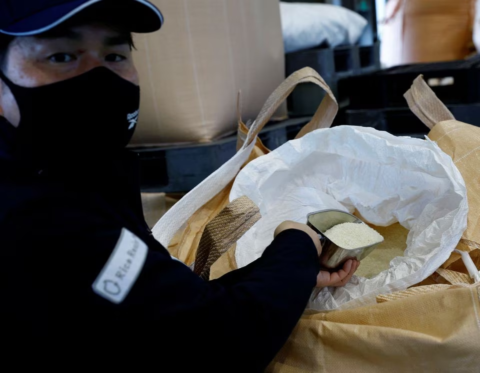 Takemitsu Imazu, President of Biomass Resin Fukushima shows rice in a sack during an interview with Reuters at its factory in Namie, about 7 km from the crippled Fukushima Dai-Ichi nuclear plant, Fukushima Prefecture, Japan February 28, 2023. Photo: Reuters