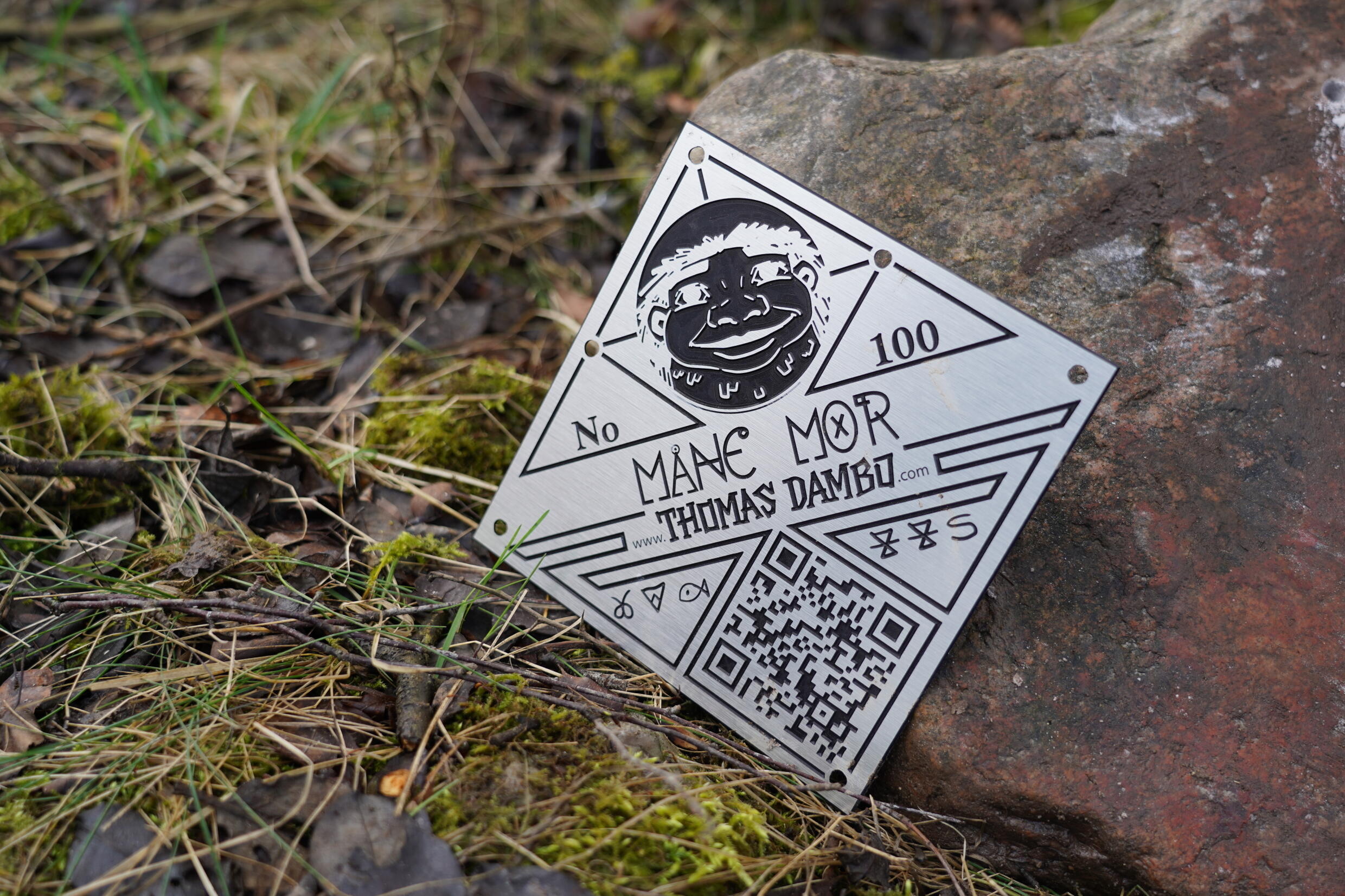 A metal plaque with a QR code clue to solving the troll mystery. Photo: AFP