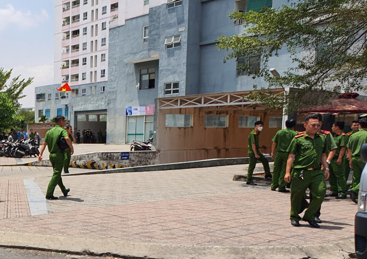Many police officers are seen at a building where Galaxy Debt Trading Company is headquartered.
