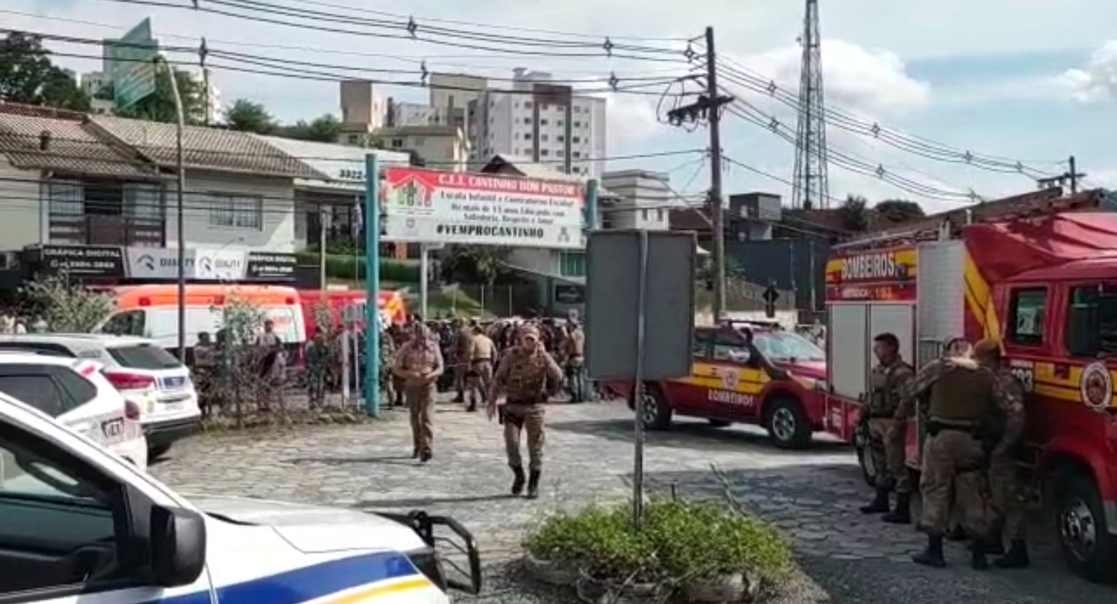 Women hug outside a pre-school after a 25-year-old man attacked children, killing several and injuring others, according to local police and hospital, in Blumenau, in the southern Brazilian state of Santa Catarina, Brazil April 5, 2023. Photo: Reuters