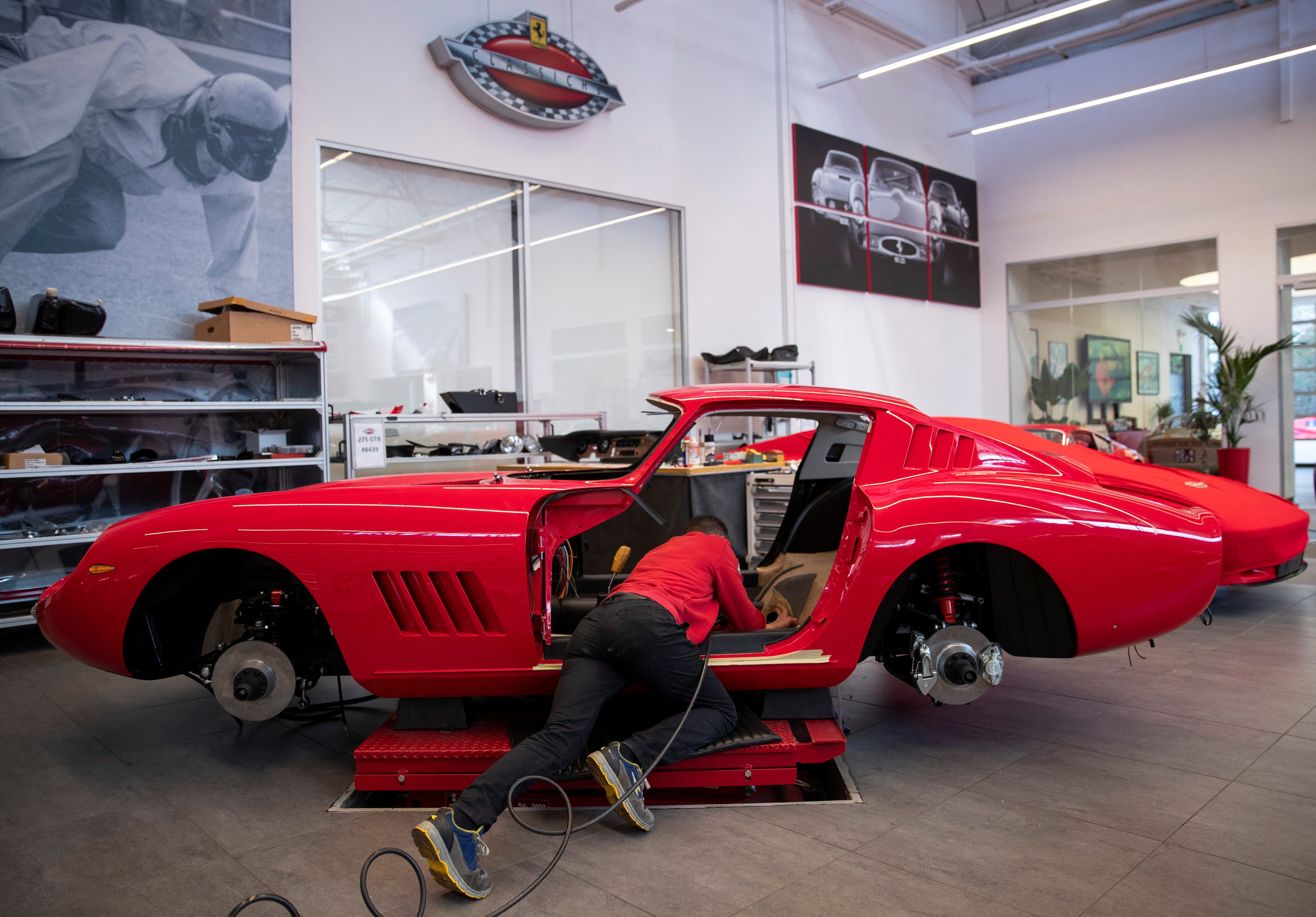 A man works on a Ferrari Classiche car in a garage at the Ferrari factory in Maranello, Italy, April 6, 2023. Photo: Reuters