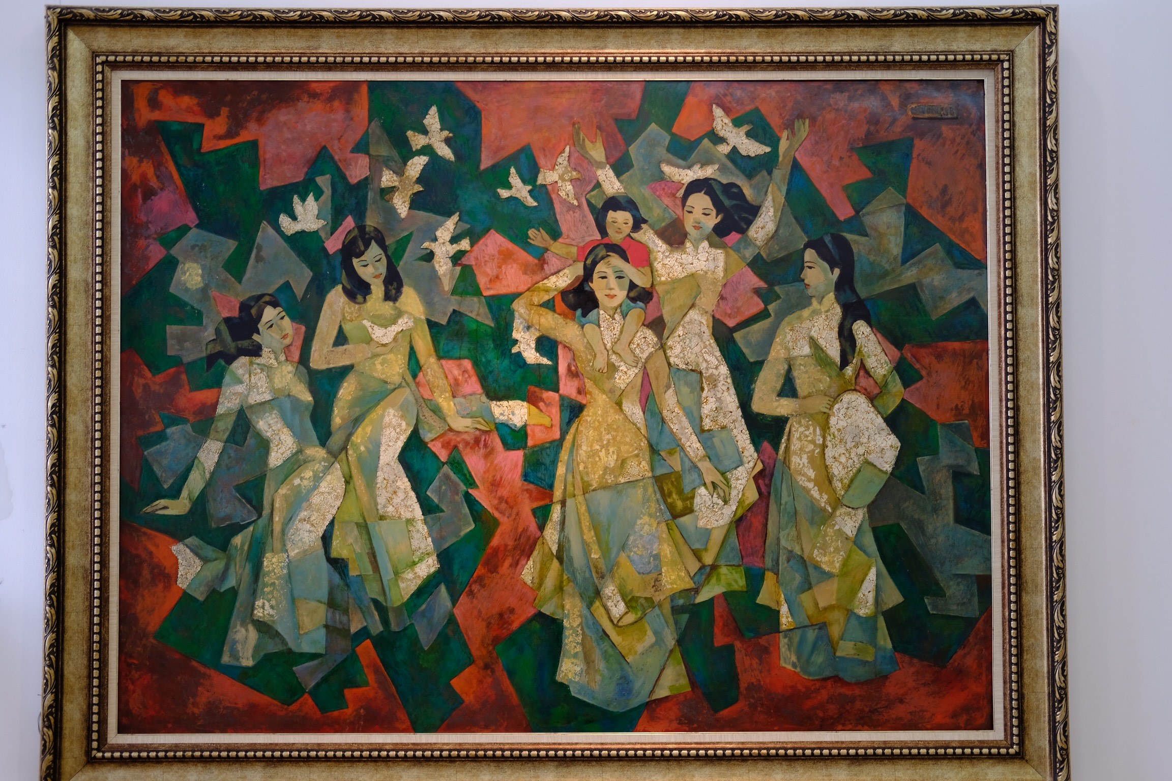 A painting titled “Thieu Nu va Chim Hoa Binh” is on show at the exhibition at IDECAF. Photo: Phuong Tran / Tuoi Tre News