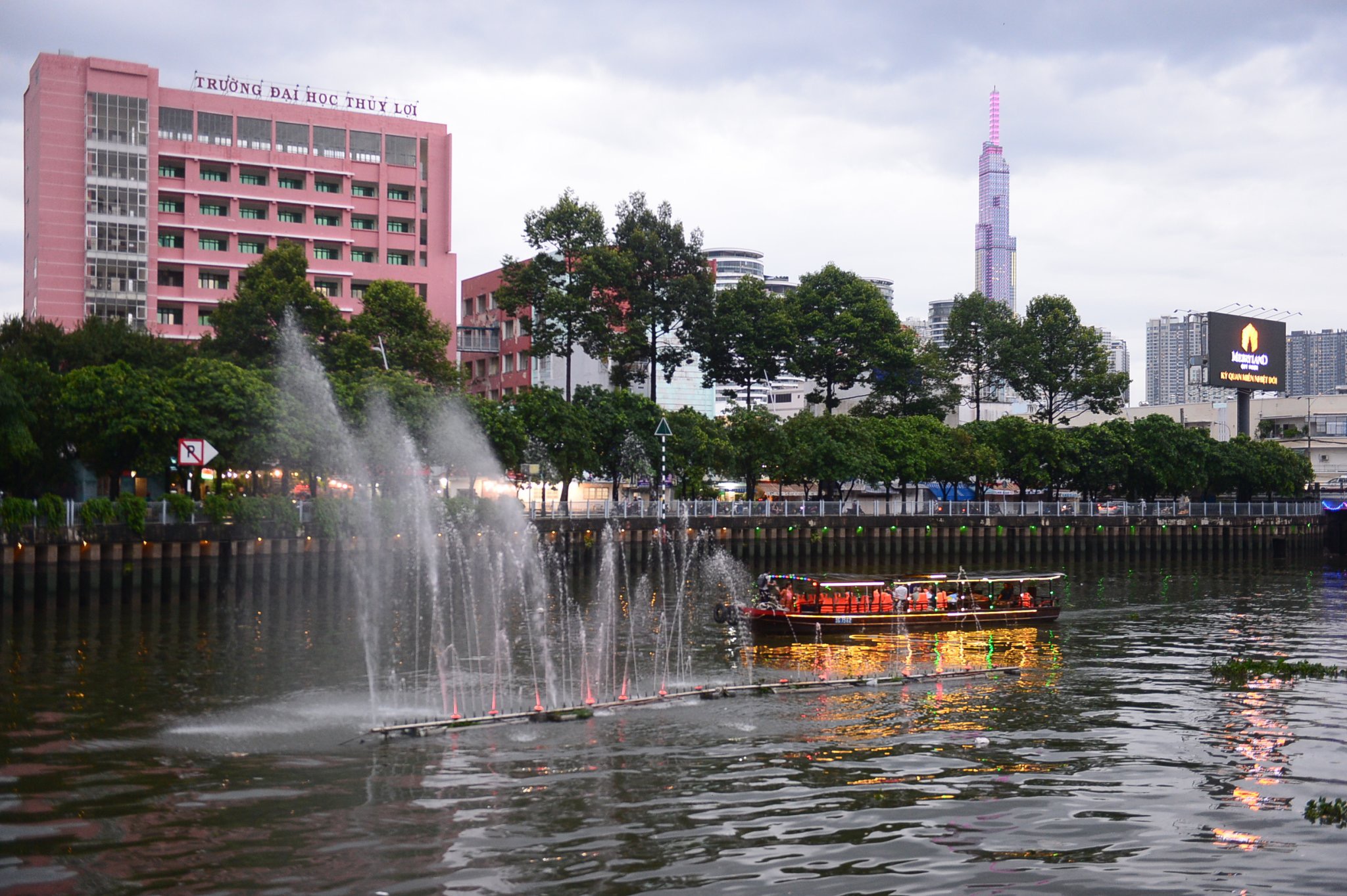 Visitors take a boat tour on Nhieu Loc - Thi Nghe Canal in Ho Chi Minh City. Photo: Quang Dinh / Tuoi Tre News