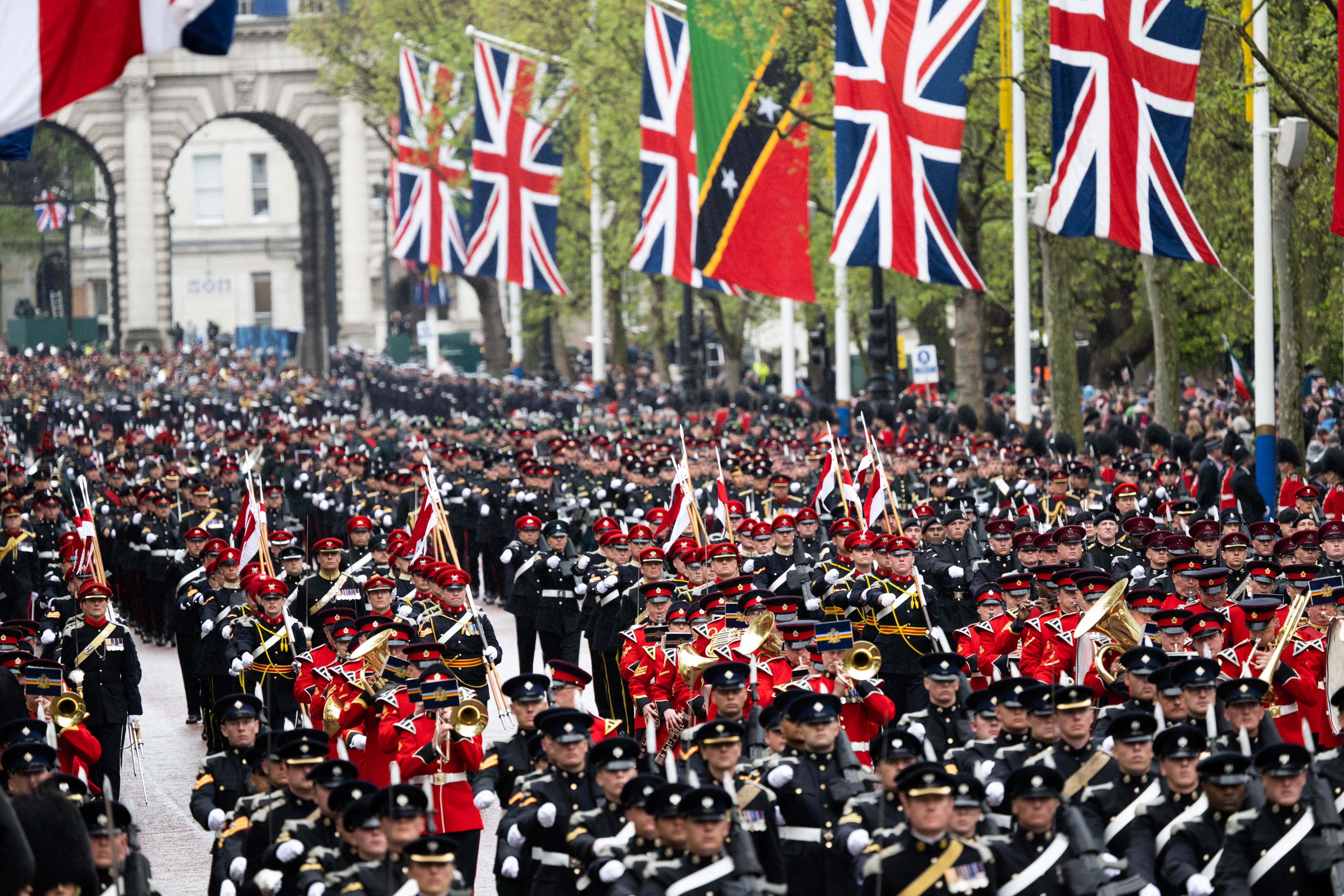 Members of the armed forces parade as crowds gather to watch the coronation procession of King Charles III and Queen Camilla in Trafalgar Square in central London Saturday May 06, 2023. Photo: Reuters