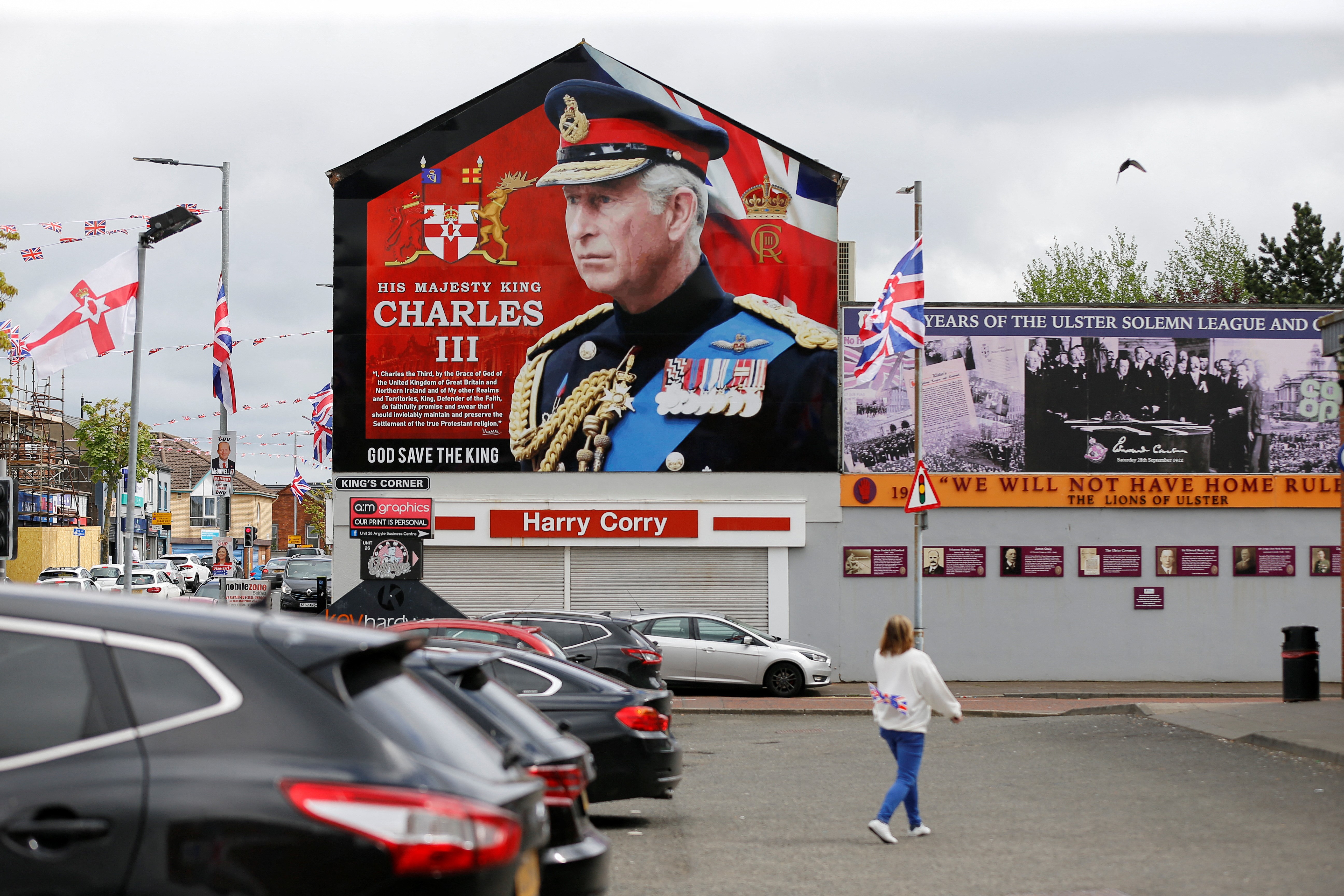 A person walks near a mural of Britain's King Charles on the side of a building, on the day of King Charles and Queen Camilla's coronation, in west Belfast, Northern Ireland May 6, 2023. Photo: Reuters