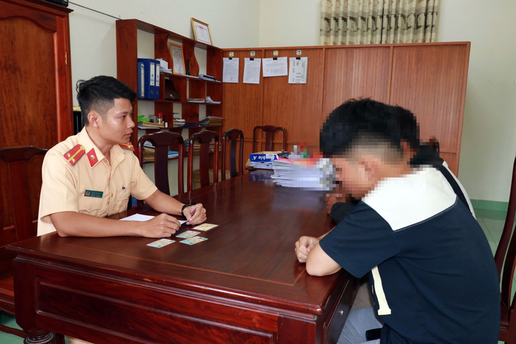 The duo are summoned to the police station for their act of a wheelie. Photo: An Binh / Tuoi Tre