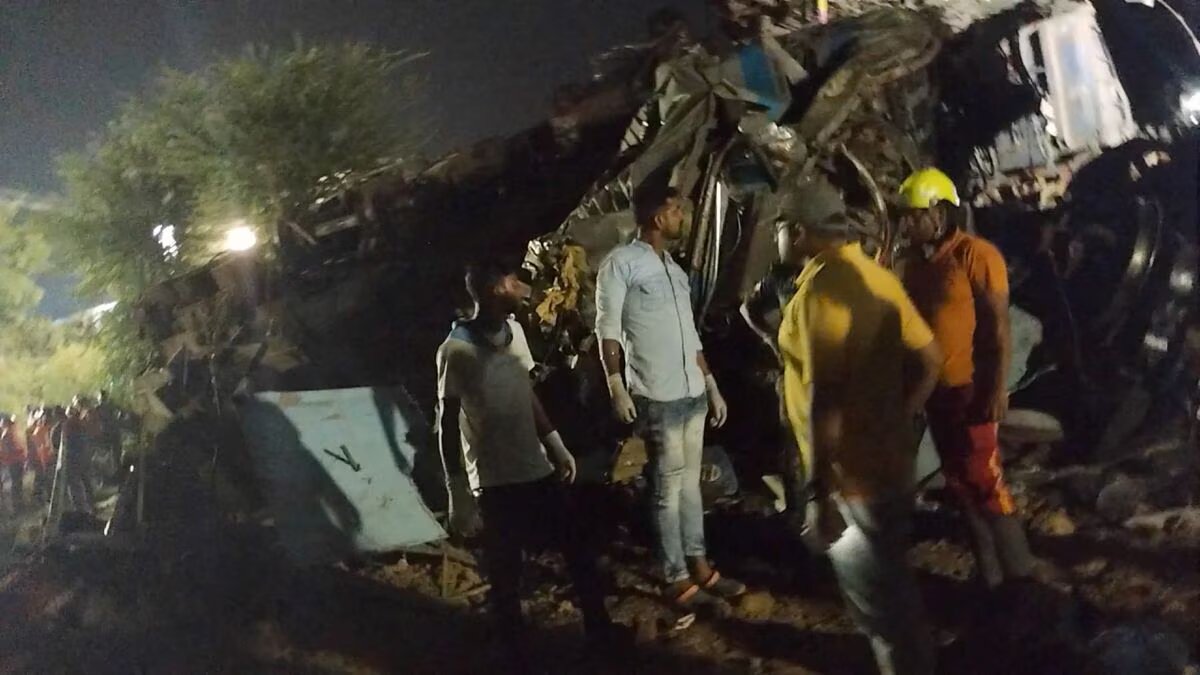 Onlookers and rescue workers stand next to damaged coaches, after trains collided in Balasore, India June 3, 2023, in this picture obtained from social media. Photo: Reuters