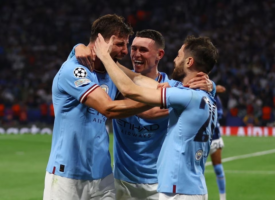 Soccer Football - Champions League Final - Manchester City v Inter Milan - Ataturk Olympic Stadium, Istanbul, Turkey - June 10, 2023 Manchester City's Bernardo Silva, Phil Foden and Ruben Dias celebrate after winning the Champions League. Photo: Reuters