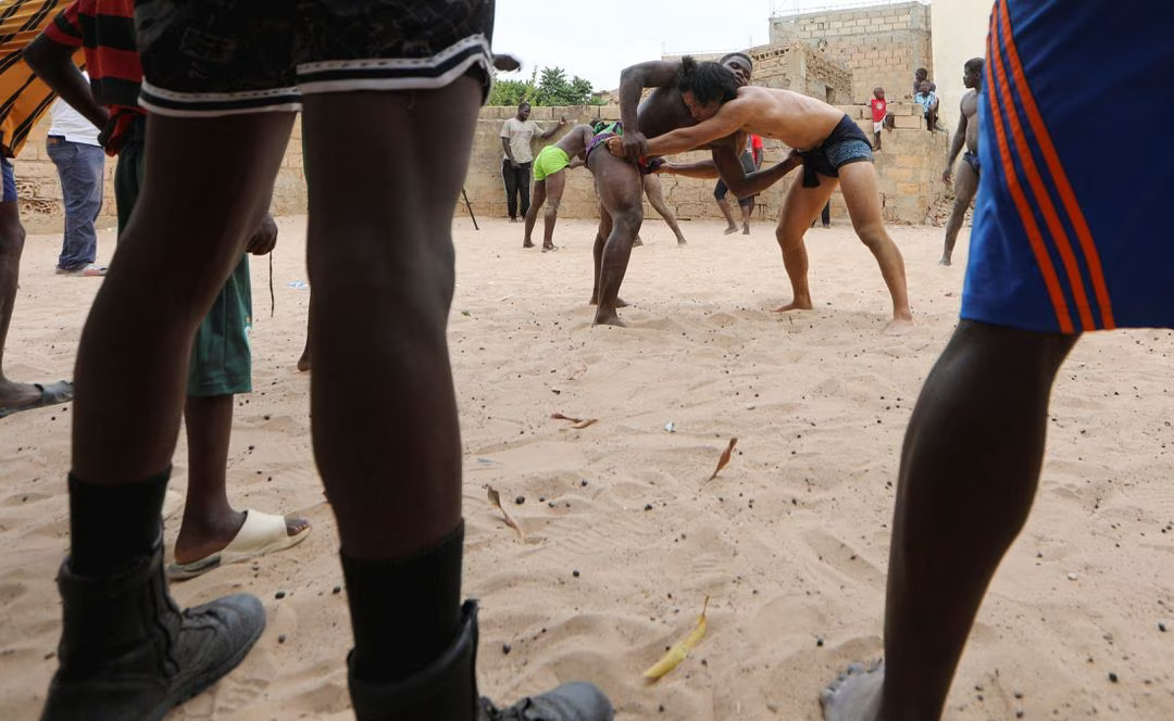 [4/5] Shogo Uozumi, known as Songo Tine, 29 years old, engages in a wrestling match against Ahmed Diop at the Samba Dia stable in the Diakhao neighbourhood, Thies, Senegal, May 26, 2023. Photo: Reuters