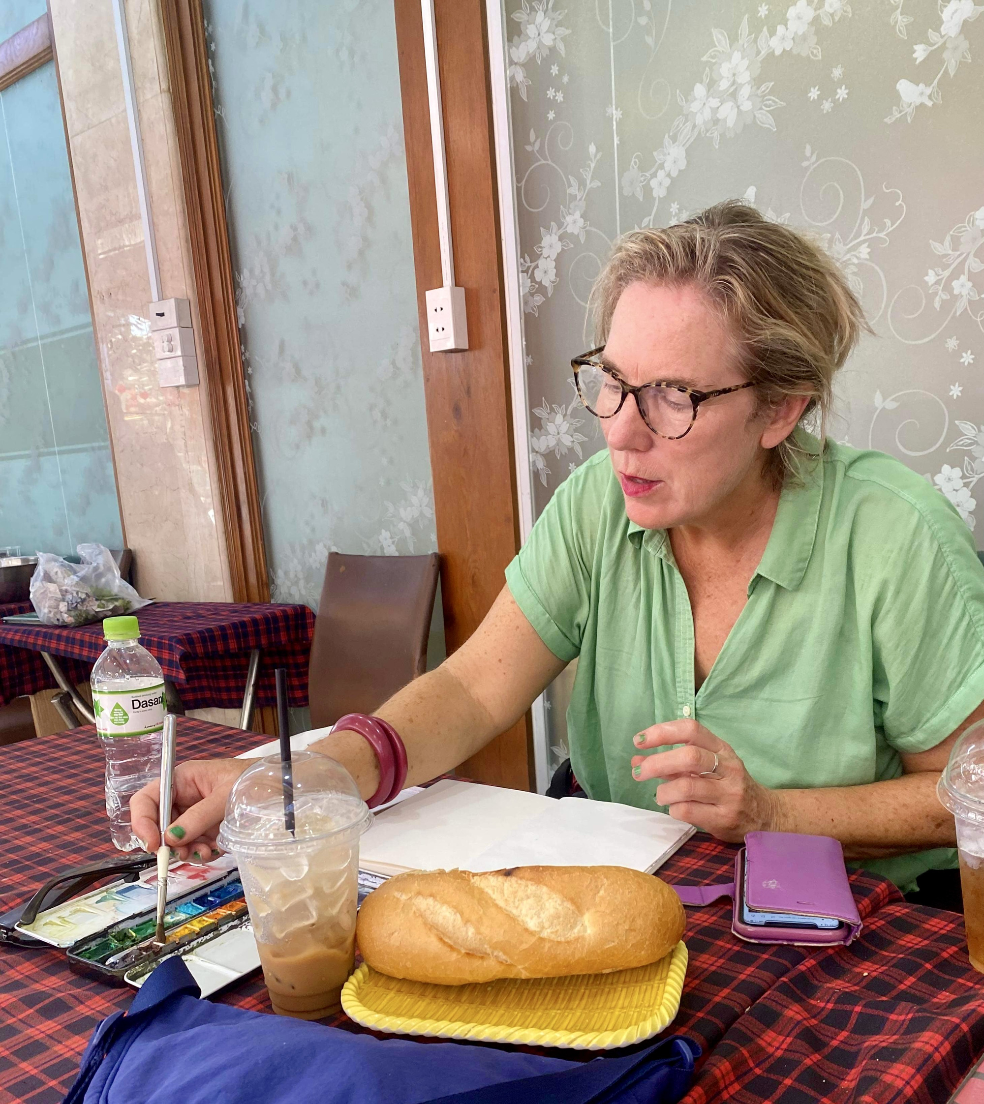 Australian art teacher Liz McGrath is working on a sketch during her recent trip to Vietnam this year. Photo: Supplied
