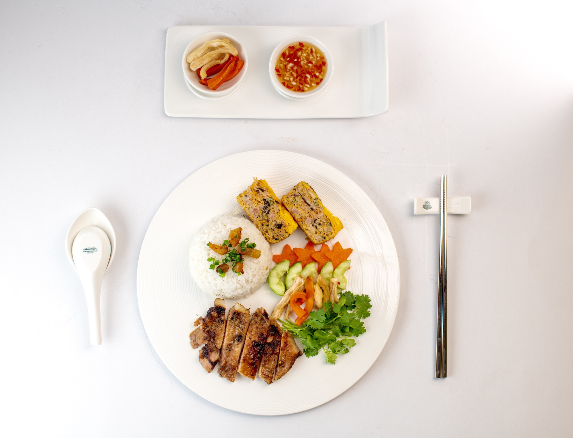 A photo shows a dish of frozen 'cơm tấm' (broken rice topped with grilled pork chop and steamed egg meatloaf) by PQ Foods after being reheated. Photo: Supplied