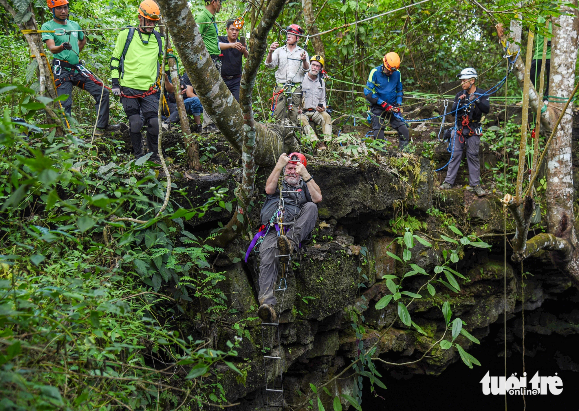 Cavers use rope ladders to enter some caves located deep inside the volcanic cavern system in Dak Nong Province in Vietnam’s Central Highlands region. Photo: Tuoi Tre