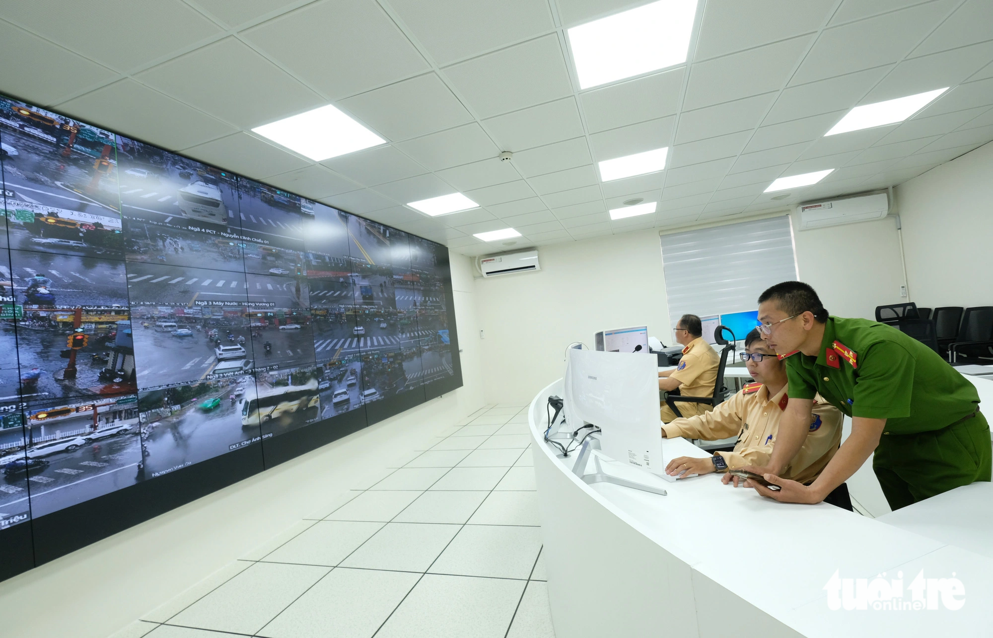 Officers observe a board of screens, which show live surveillance footage from streets in Da Lat City, Lam Dong Province, Vietnam. Photo: M.V./ Tuoi Tre