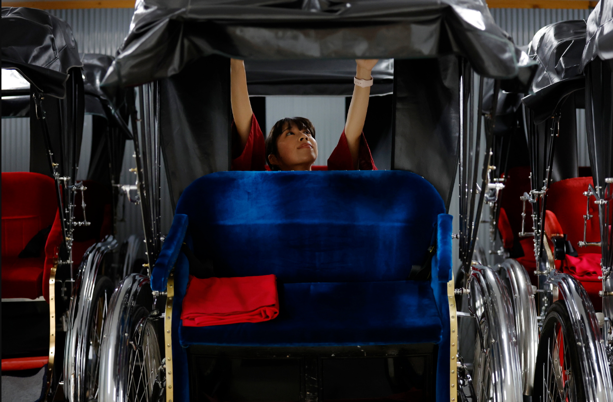 Yuka Akimoto prepares her rickshaw inside a garage at the Asakusa district in Tokyo, Japan, August 22, 2023. Photo: Reuters