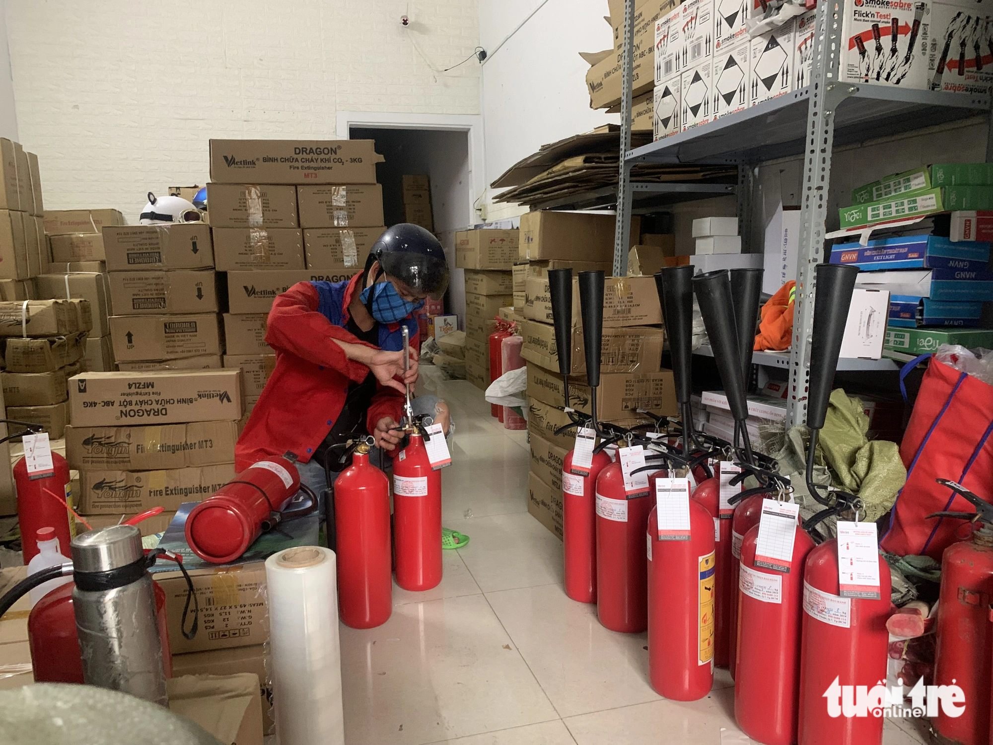 Lua Viet Company staff check fire safety products before delivery. A representative of the company said orders have skyrocketed since the mini-apartment fire in Hanoi. Photo: Quoc Viet / Tuoi Tre