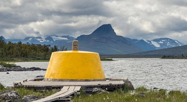 The Three-Country Cairn is placed at where the international borders of Sweden, Norway and Finland meet. Photo: Visit Lyngenfjord