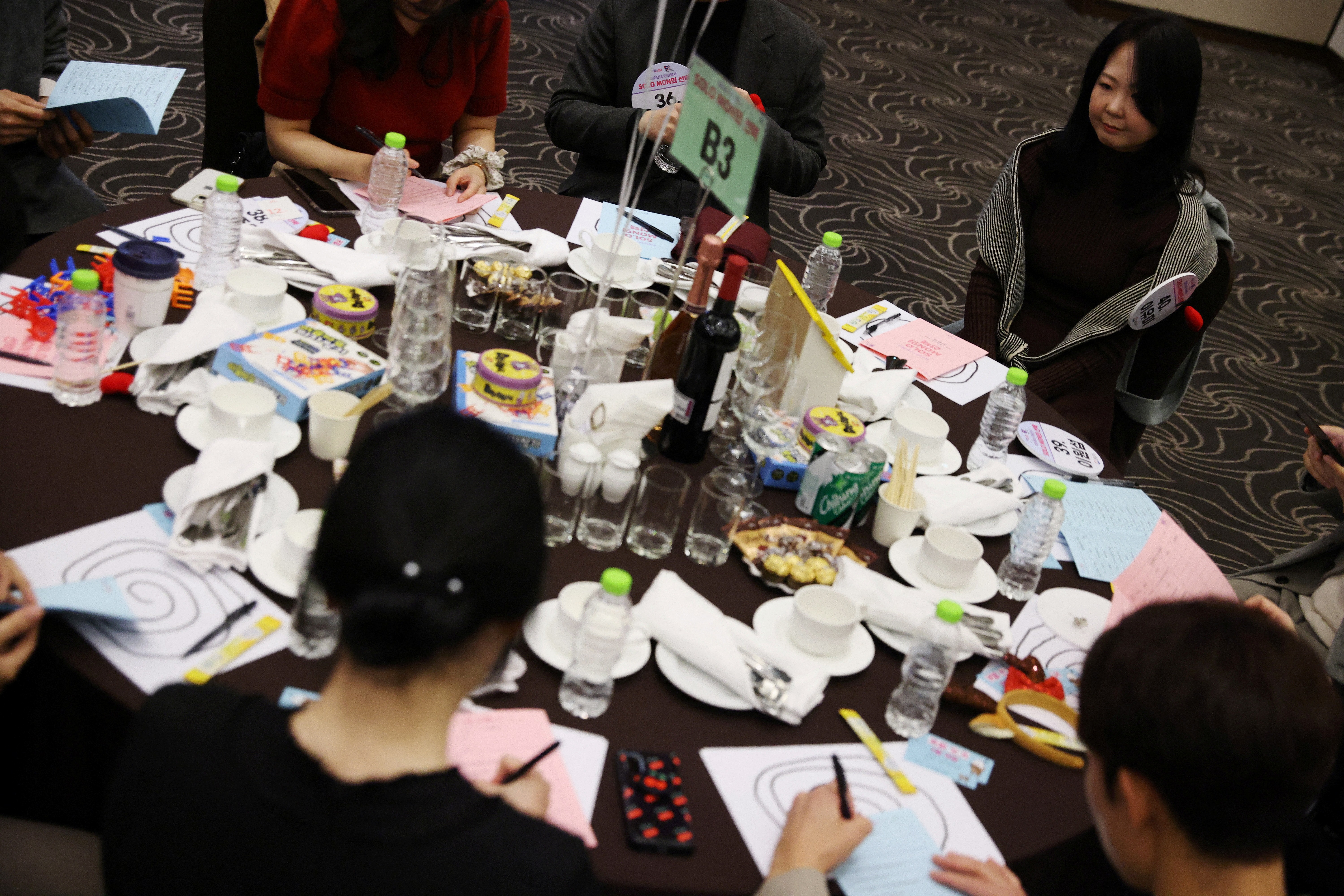 Lee Yu-mi sits along with other participants during a mass blind date event in Seongnam, South Korea, November 19, 2023. Photo: Reuters